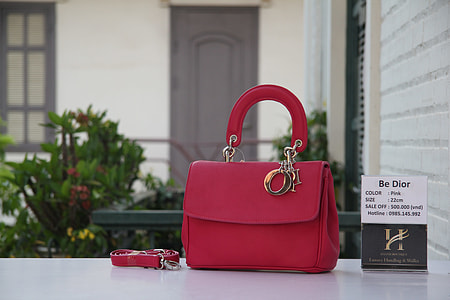 red leather handbag on white surface thumbnail