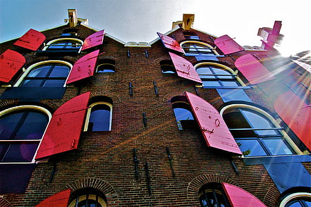 concrete building with red opened windows thumbnail