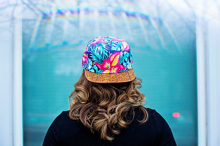 woman wearing floral cap facing back thumbnail