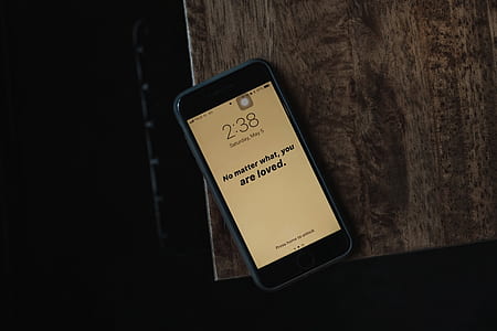 iPhone on brown wooden table thumbnail