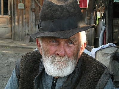 man wearing hat and black vest thumbnail