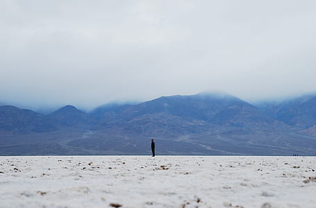man standing on beach sand thumbnail
