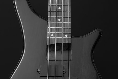 close up photography of black 4-string bass guitar thumbnail