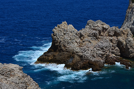 rock formation on body of water thumbnail