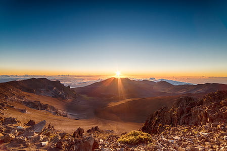 stone formation in a distance of a desert during sunset thumbnail