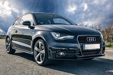 black Audi coupe under nimbus clouds thumbnail