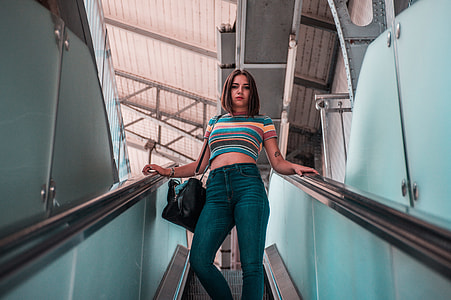 woman standing on downward escalator thumbnail
