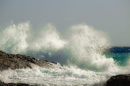 waves of water crashing on racks thumbnail