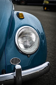 blue Volkswagen Beetle coupe on road thumbnail
