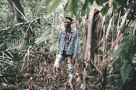 man standing surrounded by trees thumbnail