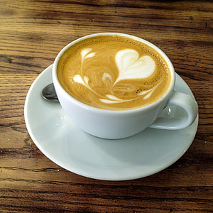 white ceramic cup with coffee on white saucer thumbnail