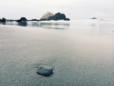 gray stone on seashore during daytime thumbnail