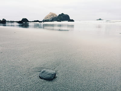 gray rock on shore thumbnail