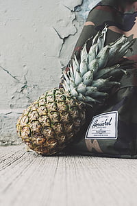 pinepapple beside bag on floor thumbnail