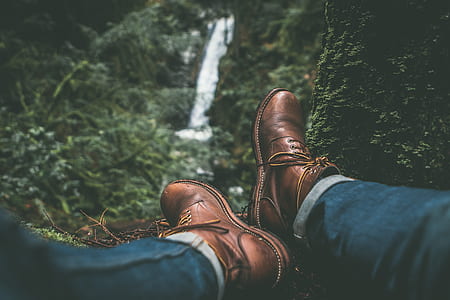 person wearing pair of brown leather mid-calf boots thumbnail