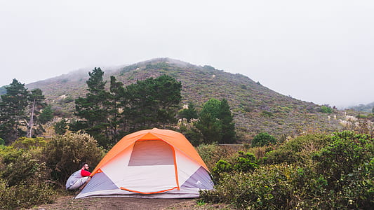 orange and gray dome tent on hill thumbnail