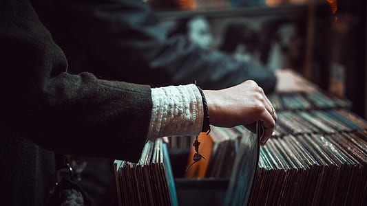 person pulling vinyl record sleeve thumbnail