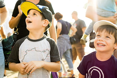 two boy standing beside each other smiling thumbnail