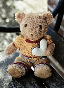 brown animal plush toy on wooden bench thumbnail