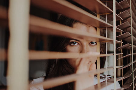 woman leaning on venetian blind thumbnail