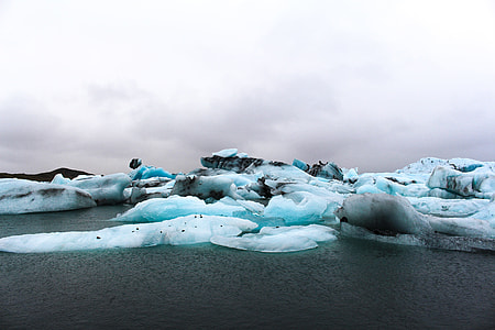ice burgs on ocean under white clouds thumbnail