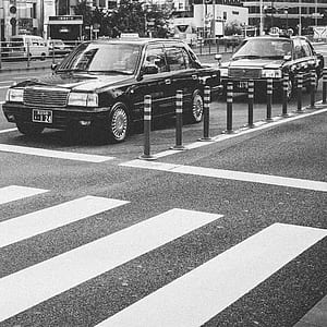 two black car stationed behind pedestrian lane thumbnail