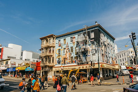 group of people walking on street in front of building structures during daytime thumbnail