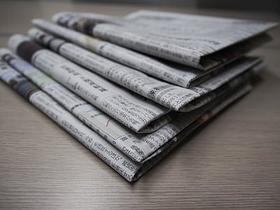 newspapers on top of gray board thumbnail