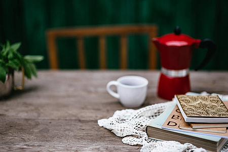 Stack of organizers and red italian coffee maker thumbnail