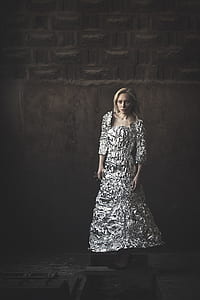 woman wearing white foil dress in front of gray wall thumbnail