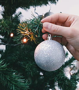 Person Holding Silver Glittered Bauble thumbnail