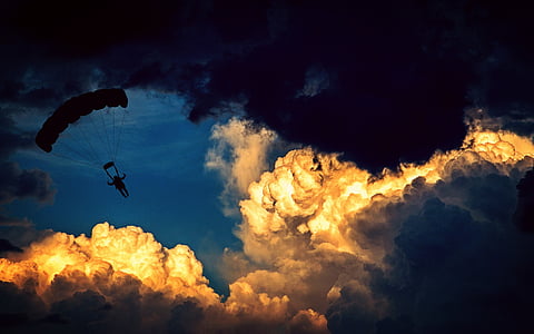 man in parachute during night time thumbnail