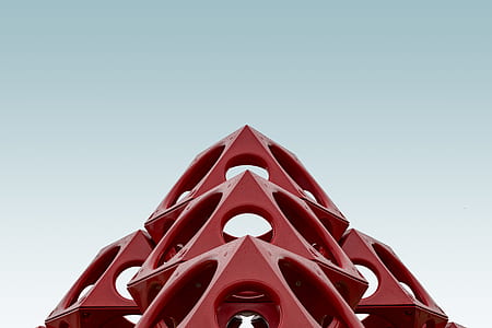 low-angle photography of red building under grey sky thumbnail