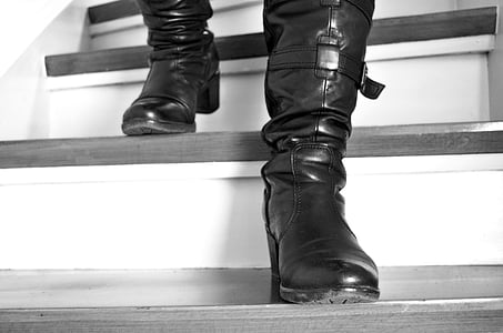 person wearing black leather round-toe chunky heeled boots going down the stairs thumbnail