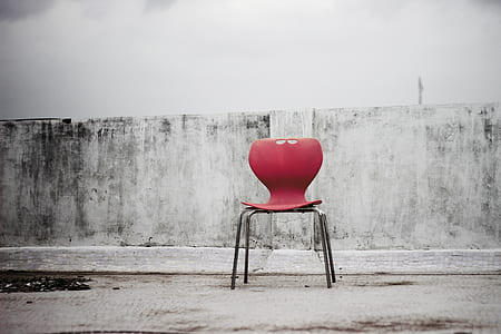 red chair near gray concrete wall thumbnail