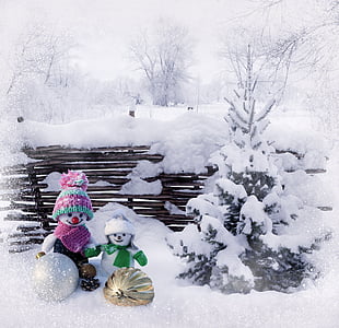 two snowmen beside snowy tree thumbnail