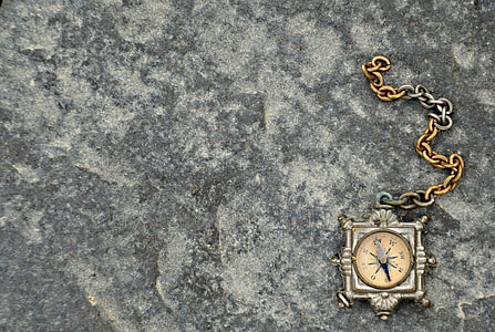 square silver framed watch with chain on pavement thumbnail