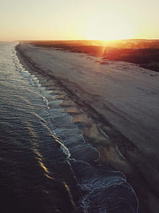 aerial photography of coastline at golden hour thumbnail