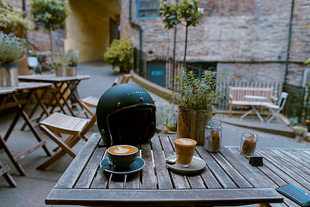 black half-face helmet on brown wooden table thumbnail
