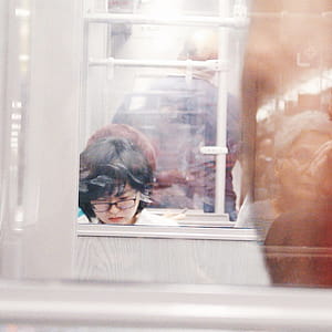 Woman Wearing Eyeglasses Reflection on Mirror thumbnail