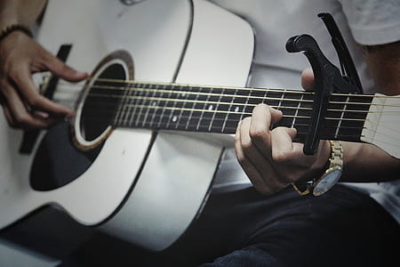 Man Holding a White Dreadnought Acoustic Guitar thumbnail