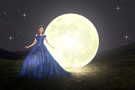 woman in blue ball gown standing on field with full moon backdrop thumbnail
