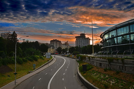 road beside the building under blue sky thumbnail