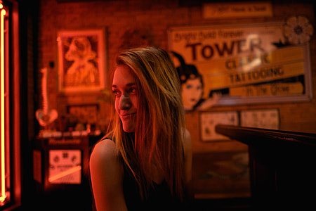 woman in black tank top smiling taking photo thumbnail
