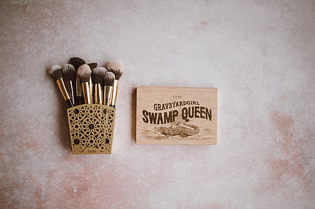 brown make-up brush set on brown steel rack beside Swamp Queen makeup palette thumbnail