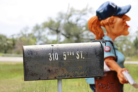 gray mailbox near statue thumbnail