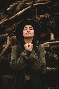 woman closing eyes while looking up at daytime thumbnail