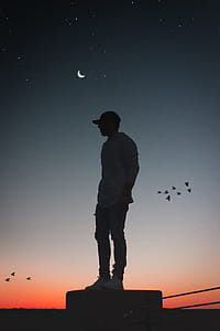 Silhouette Photo of Man Standing on Concrete Surface thumbnail