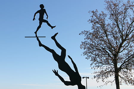 silhouette of men beside tree thumbnail