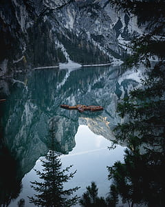 mountain and trees with reflection in body of water thumbnail